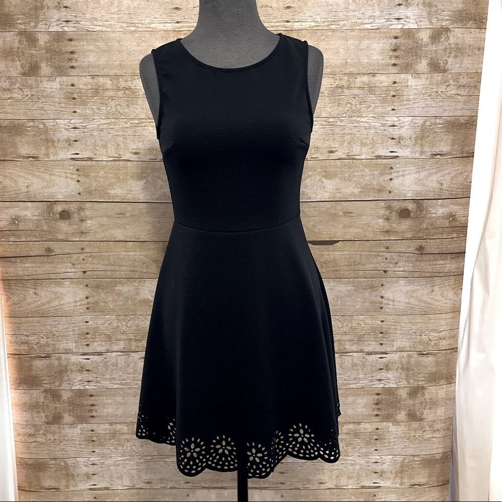 Black sleeveless sheath dress. Size medium. Delicate cut out hem.